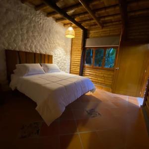 a bedroom with a bed in a room with a window at Costello Campestre in San Alfonso