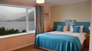 a bedroom with a bed and a large window at Torlinnhe Guest House in Fort William