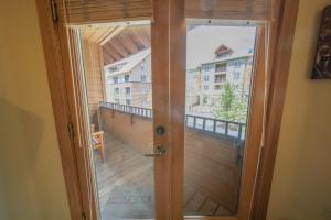 uma porta de madeira com vista para uma varanda em Arapahoe Lodge 8116 em Keystone