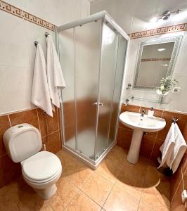 een badkamer met een douche, een toilet en een wastafel bij Apartments Štokić in Rab