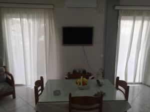 a living room with a table with a bowl of fruit on it at Panos & Antzy Apartments in Kalamata