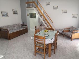 a living room with a table and a couch at Panos & Antzy Apartment in Kalamata