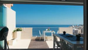 a balcony with a table and a view of the ocean at Malù Bed&Breakfast in Polignano a Mare