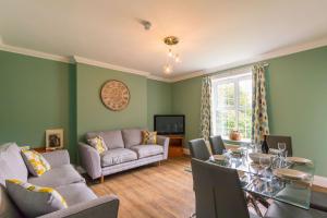 a living room with a table and a couch at Redwings Sanctuary Rooms - Norfolk Holiday Properties 