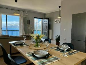 a dining room table with a view of the ocean at Coralli Pentati 1 "Dimitris Apartments" in Pentátion