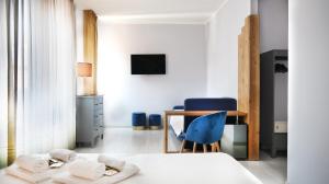 a bedroom with a bed and a desk and a chair at Hotel Riviera in Desenzano del Garda