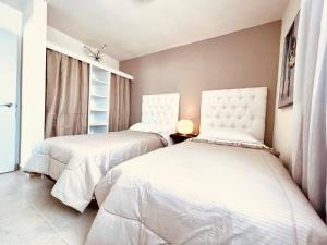 a bedroom with two beds and a window at Luxury Apartment with Great Location 2-A in Matamoros