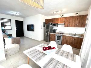 a kitchen with a table with apples on it at Luxury Apartment with Great Location 2-A in Matamoros
