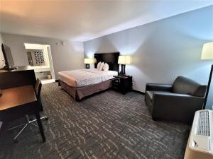 a hotel room with a bed and a couch at Inn Of Rockwall in Rockwall