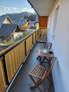 a balcony with a wooden table and chairs on it at Vila Rajska ptica in Bled