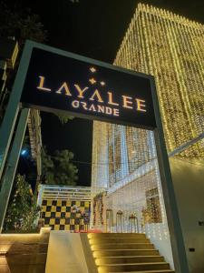 a sign for aalle grande in front of a building at Layalee Grande Hotel Chennai in Chennai