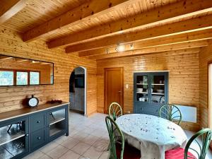 a kitchen with a table and chairs in a room at Chalet de Fréland in Fréland