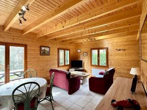 a living room with wooden walls and a wooden ceiling at Chalet de Fréland in Fréland