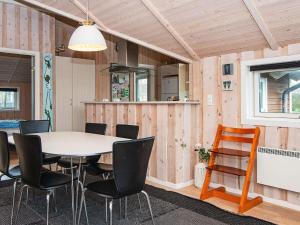 a kitchen and dining room with a table and chairs at Three-Bedroom Holiday home in Hemmet 55 in Hemmet