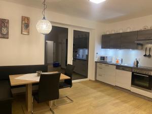 a kitchen with a table and a dining room at Wohnung City Nord mit Balkon in Herzogsdorf