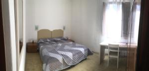 Giường trong phòng chung tại Appartamento Villanova