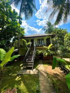 a house with a staircase leading up to it at Liyon Rest in Sigiriya