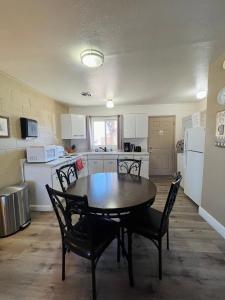 a kitchen with a table and chairs in a room at Lake Powell Motel & Apartments in Page