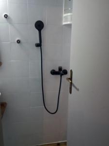 a shower with a hose in a bathroom stall at Clock's House in Nafpaktos