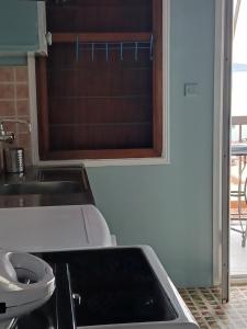 a kitchen with a sink and a toilet at Clock's House in Nafpaktos