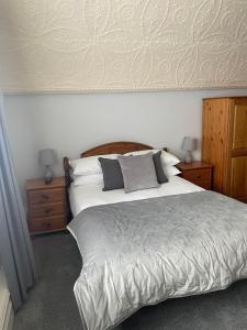 a bedroom with a large bed with two night stands and two lamps at The Lugger Fowey in Fowey