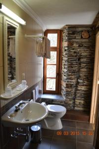 a bathroom with a sink and a toilet and a window at Auberge Au Naturel des Ardennes in Rochehaut