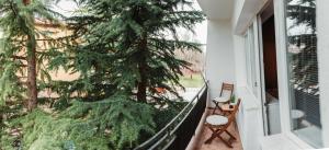 a balcony with a christmas tree on the fence at Heart City Apartment in Ohrid