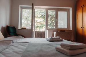 a bedroom with a bed with two towels on it at Heart City Apartment in Ohrid