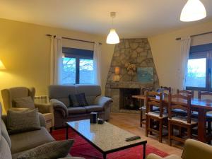 a living room filled with furniture and a fireplace at Casa Rural Fuentecillas in Becedas