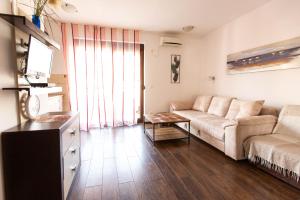 a living room with a couch and a table at Apartment lora in Budva