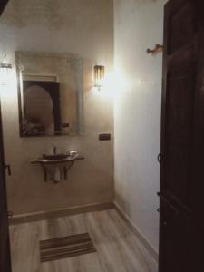 a bathroom with a sink and a mirror on the wall at Riad Sidi Hicham in Marrakesh