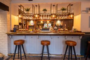 a bar with two stools in front of it at Woodroffe Arms, Hope Room 3 in Hope