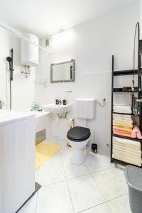 a white bathroom with a toilet and a sink at Apartment 123 for you in Split