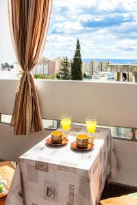 a table with two glasses of orange juice on a balcony at Apartment 123 for you in Split