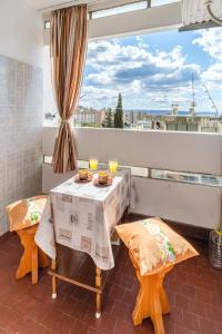 a balcony with a table and two chairs and a window at Apartment 123 for you in Split