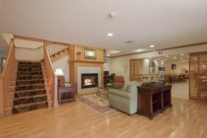 a living room with a couch and a fireplace at Country Inn & Suites by Radisson, Davenport, IA in Davenport