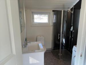 a small bathroom with a sink and a toilet at Guest House Stare in Strömstad