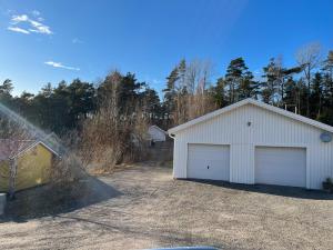 a white garage next to a driveway at Guest House Stare in Strömstad