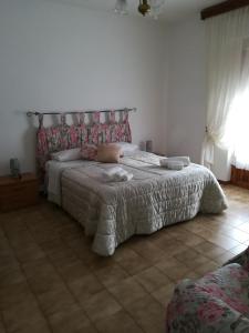 a bedroom with a large bed in a room at Alloggio turistico La nuova Velzna in Bolsena +38 photos