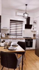 a kitchen with a table and chairs in a room at Ina's apartments in Lefkimmi