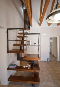 a spiral staircase in a living room with wooden floors at Mare e Pietra in Monemvasia