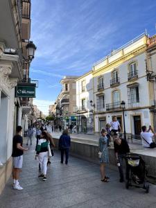 a group of people walking down a city street at ANGELFLAT CENTRO in Ronda