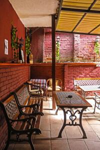 a patio with benches and a table in a restaurant at Hostel 42 in Skopje