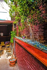 a brick wall with potted plants on top of it at Hostel 42 in Skopje