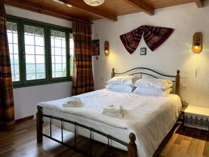 a bedroom with a large bed with towels on it at Villa Kamari- Stunning Views in Kritsá