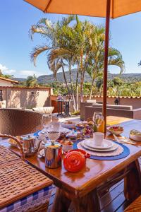 a wooden table with food on top of a patio at Jardim Do Eden Piri in Pirenópolis