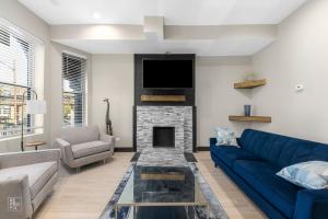 a living room with a blue couch and a fireplace at Romantic 3 Bed Home In The Heart Of The Park in Chicago