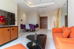 a living room with a couch and a table at The Rixx Spectacular Apartment @ Opera House-Hyatt in Ho Chi Minh City