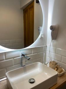 a bathroom with a sink and a mirror at Posada de Lola in El Molar