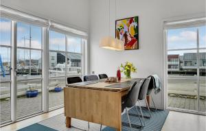 a office with a desk with chairs and windows at Hummeren 164 in Ebeltoft